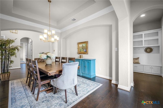 dining area featuring visible vents, crown molding, baseboards, a raised ceiling, and dark wood-style flooring