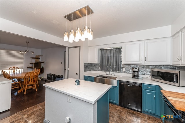 kitchen with a center island, blue cabinets, black dishwasher, white cabinetry, and decorative light fixtures