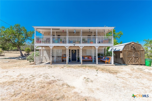 back of property with a storage unit and a wooden deck