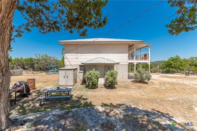 back of house with a balcony