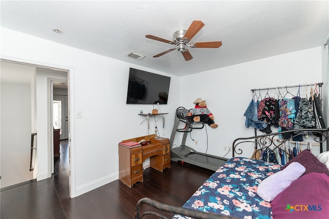 bedroom featuring a textured ceiling, ceiling fan, and dark hardwood / wood-style floors