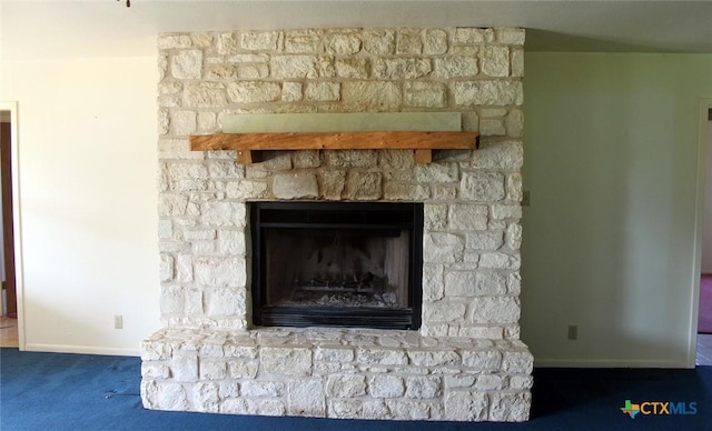 854 Pettytown Rd, Red Rock, TX 78662 - detailed view of baseboards, a fireplace with raised hearth, and carpet