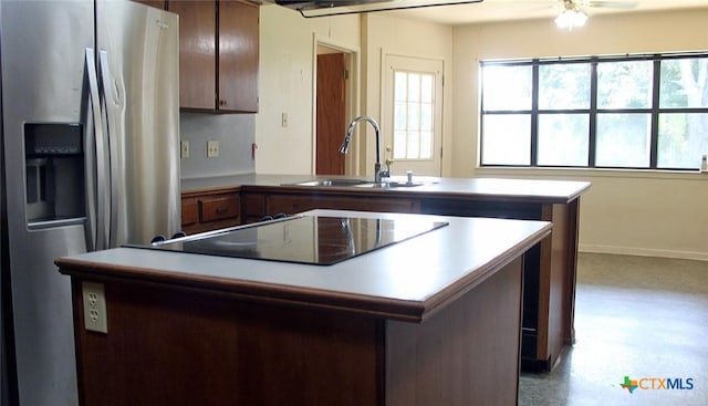 854 Pettytown Rd, Red Rock, TX 78662 - kitchen with stainless steel fridge with ice dispenser, a sink, a peninsula, a kitchen island, and black electric cooktop