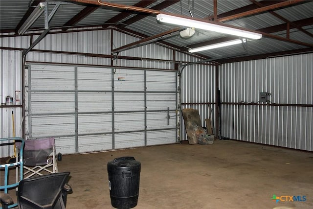 854 Pettytown Rd, Red Rock, TX 78662 - garage featuring metal wall and a garage door opener