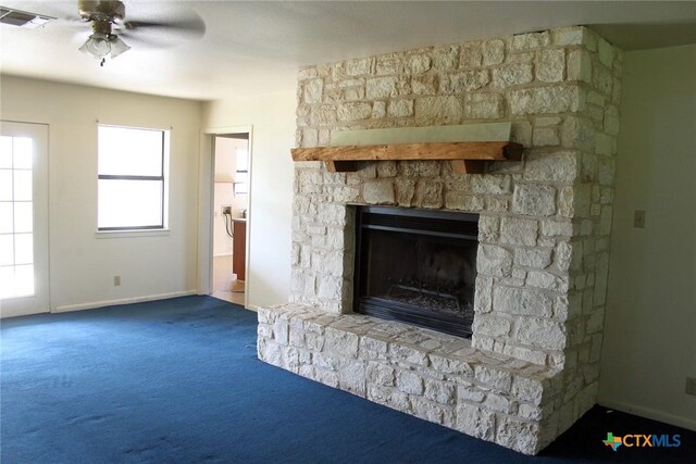 854 Pettytown Rd, Red Rock, TX 78662 - unfurnished living room featuring carpet, a fireplace, a ceiling fan, and baseboards