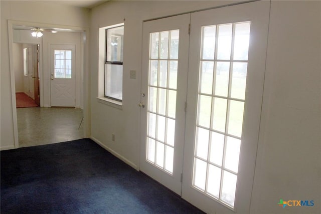 854 Pettytown Rd, Red Rock, TX 78662 - doorway to outside featuring ceiling fan, baseboards, and dark colored carpet
