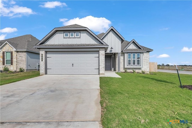 view of front of property featuring a front yard and a garage