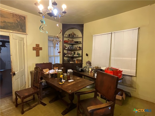 dining area featuring a notable chandelier