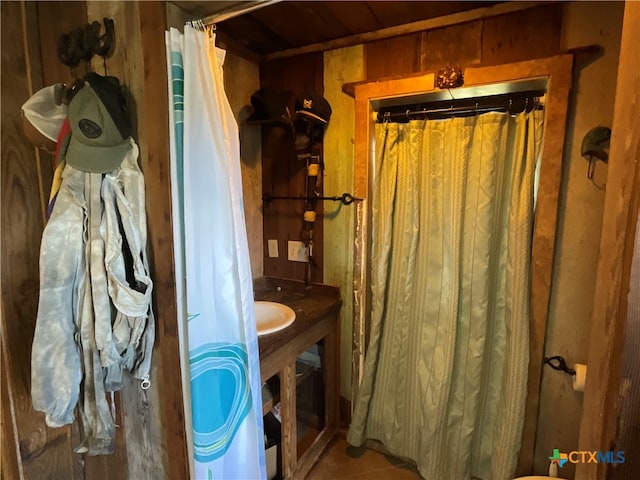 bathroom with wood walls