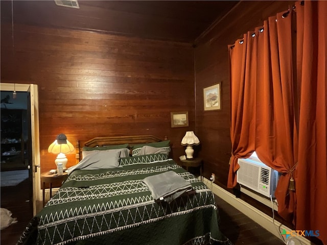 bedroom featuring wood walls and cooling unit