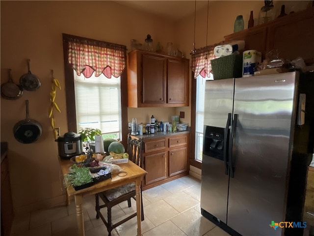 kitchen with stainless steel fridge and light tile patterned floors