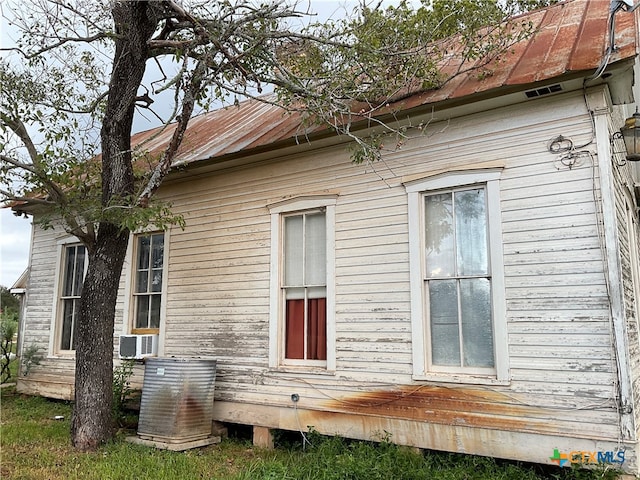 view of side of property with cooling unit