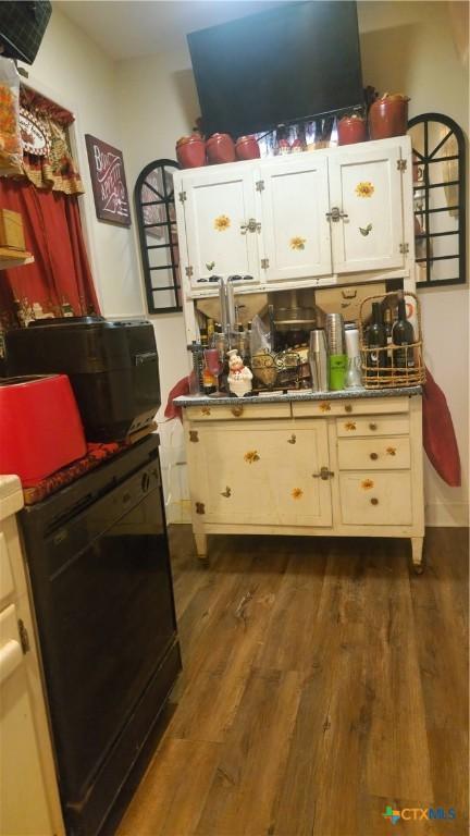701 E Anaqua Ave, Victoria, TX 77901 - kitchen with black dishwasher and dark wood-type flooring