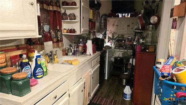 701 E Anaqua Ave, Victoria, TX 77901 - kitchen with open shelves, a sink, and dark wood-type flooring