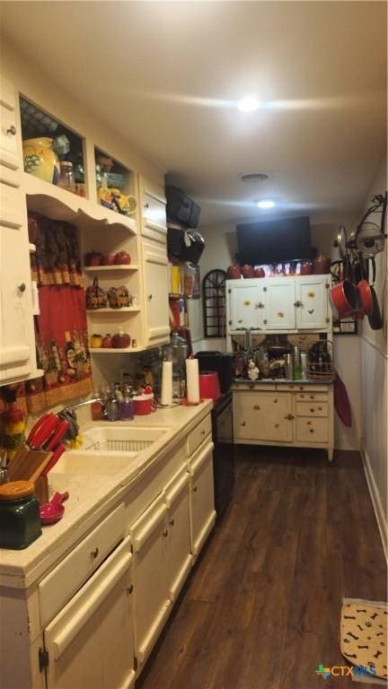 701 E Anaqua Ave, Victoria, TX 77901 - kitchen featuring light countertops, dark wood-type flooring, white cabinetry, open shelves, and dishwasher