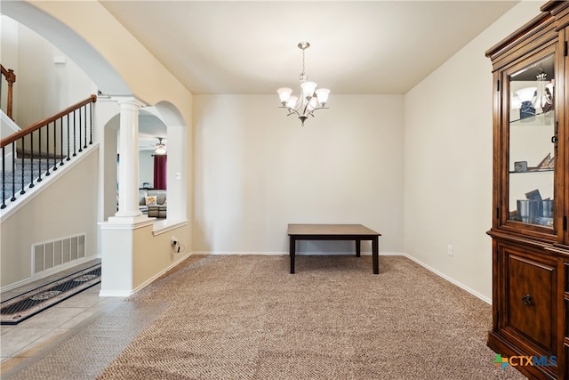 interior space with ornate columns and ceiling fan with notable chandelier