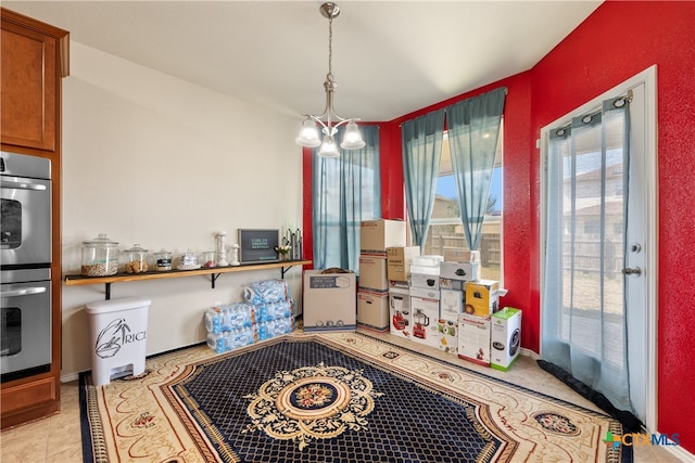 interior space with light tile patterned floors and an inviting chandelier