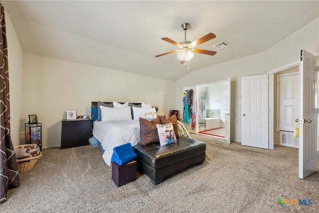 bedroom with carpet, ceiling fan, connected bathroom, and vaulted ceiling