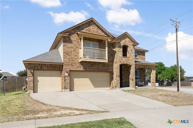 view of front of house with a garage and a balcony