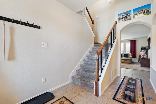 stairs with tile patterned floors