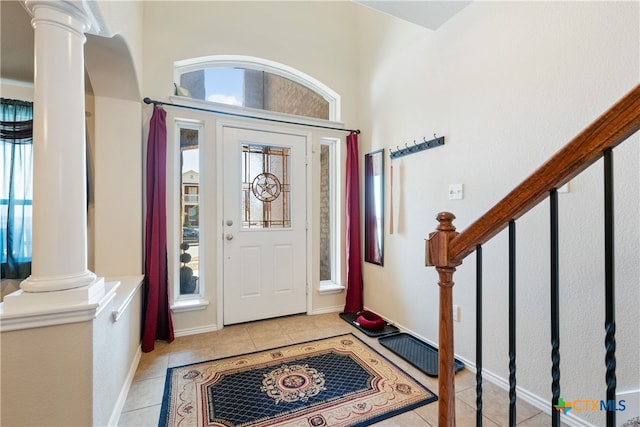 tiled entryway featuring decorative columns