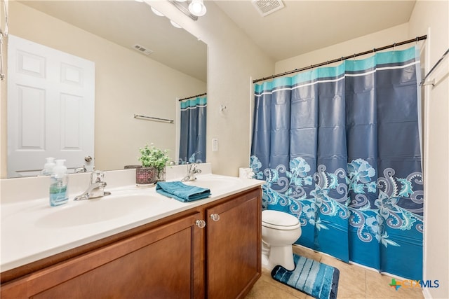 bathroom featuring tile patterned floors, a shower with curtain, vanity, and toilet