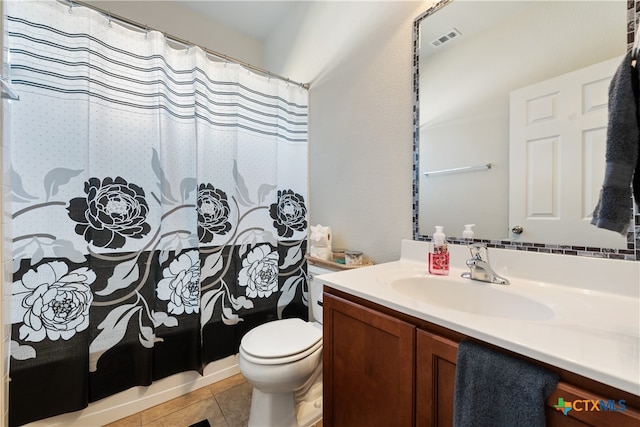 bathroom with toilet, vanity, tile patterned floors, and curtained shower