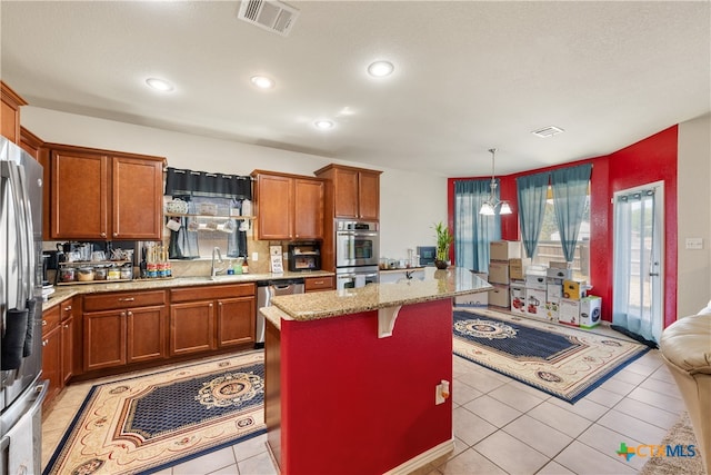 kitchen with a center island, a kitchen breakfast bar, tasteful backsplash, decorative light fixtures, and appliances with stainless steel finishes