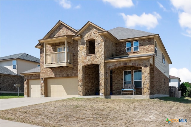 view of front of home featuring a balcony and a garage