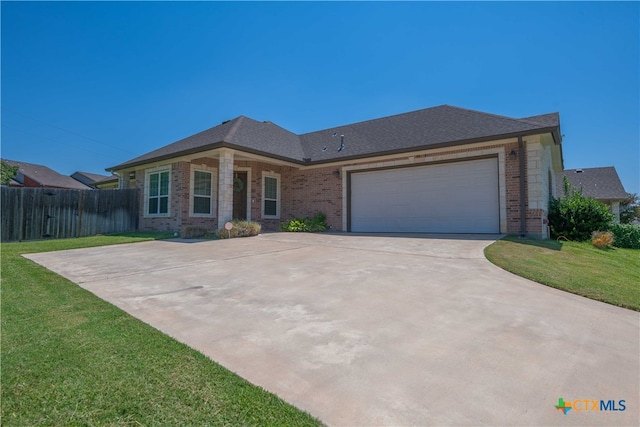 view of front of house featuring a garage and a front lawn