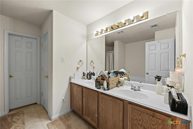 bathroom featuring tile patterned flooring and vanity