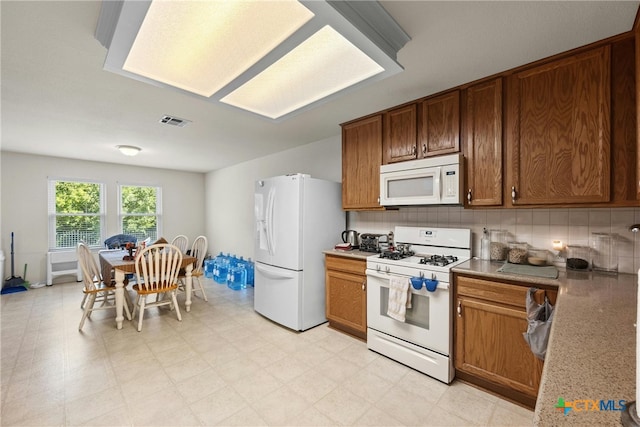 kitchen with backsplash and white appliances