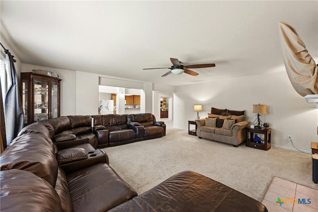 carpeted living room with ceiling fan