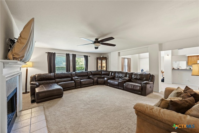 carpeted living room with ceiling fan