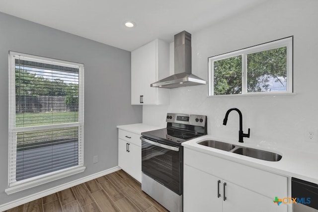 5073 Cedarside, San Marcos, TX 78666 - kitchen with wall chimney range hood, electric stove, light countertops, white cabinets, and recessed lighting