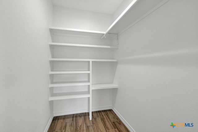 5073 Cedarside, San Marcos, TX 78666 - walk in closet featuring dark wood-type flooring