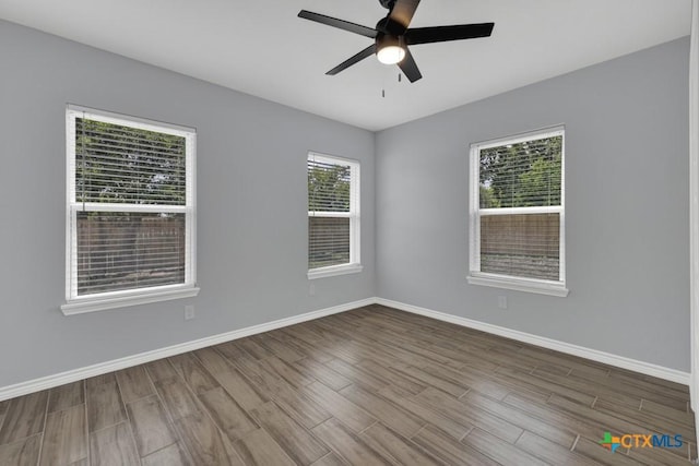 5073 Cedarside, San Marcos, TX 78666 - spare room featuring wood finished floors, healthy amount of natural light, and a ceiling fan