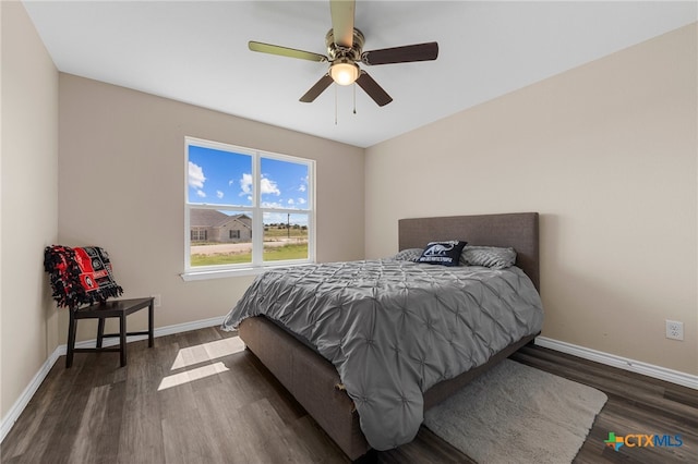 bedroom with ceiling fan and dark hardwood / wood-style floors