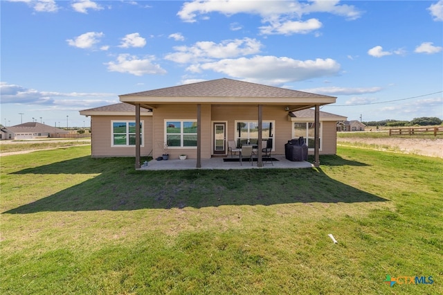 back of house with a patio area and a yard