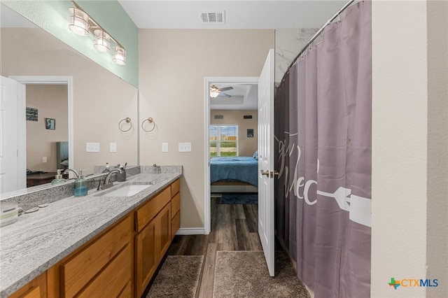 bathroom featuring wood-type flooring, ceiling fan, and vanity