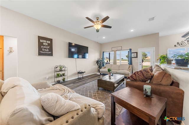 living room featuring dark hardwood / wood-style floors and ceiling fan