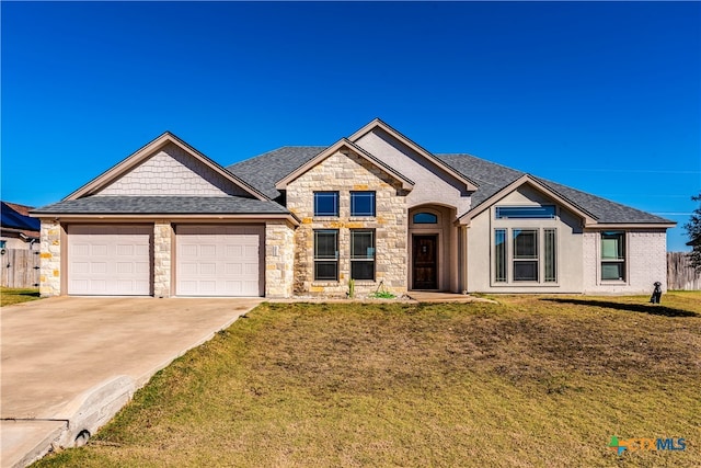 view of front of home featuring a garage and a front lawn