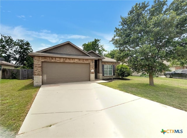 view of front of home with a garage and a front lawn