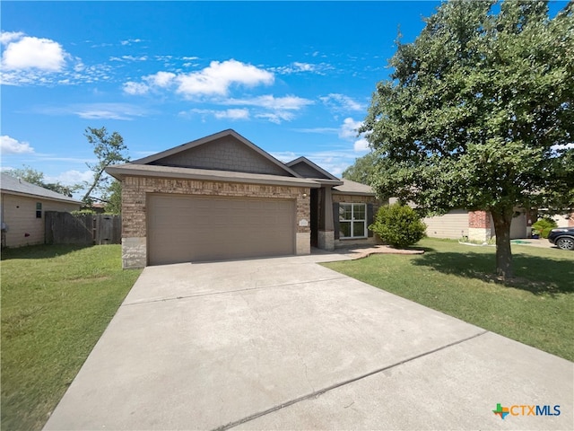 view of front of home with a garage and a front lawn