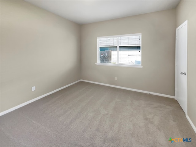 unfurnished room with light colored carpet