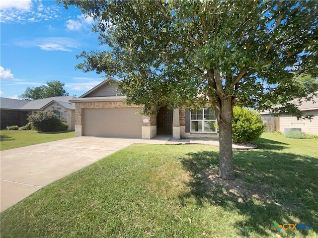 obstructed view of property with a front yard and a garage