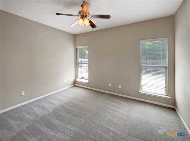 carpeted empty room featuring ceiling fan