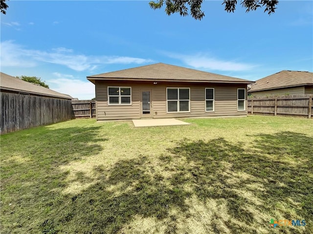 rear view of property with a lawn and a patio area