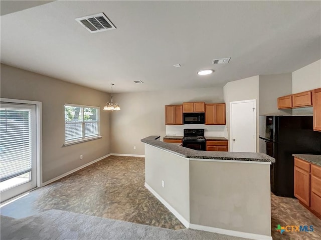 kitchen with an inviting chandelier, hanging light fixtures, a kitchen island, and black appliances