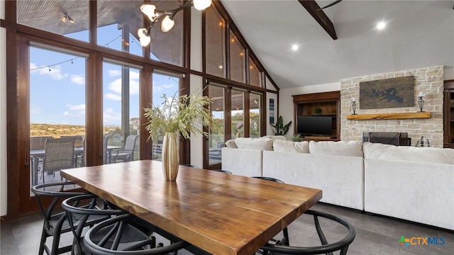 dining room with expansive windows, high vaulted ceiling, and plenty of natural light